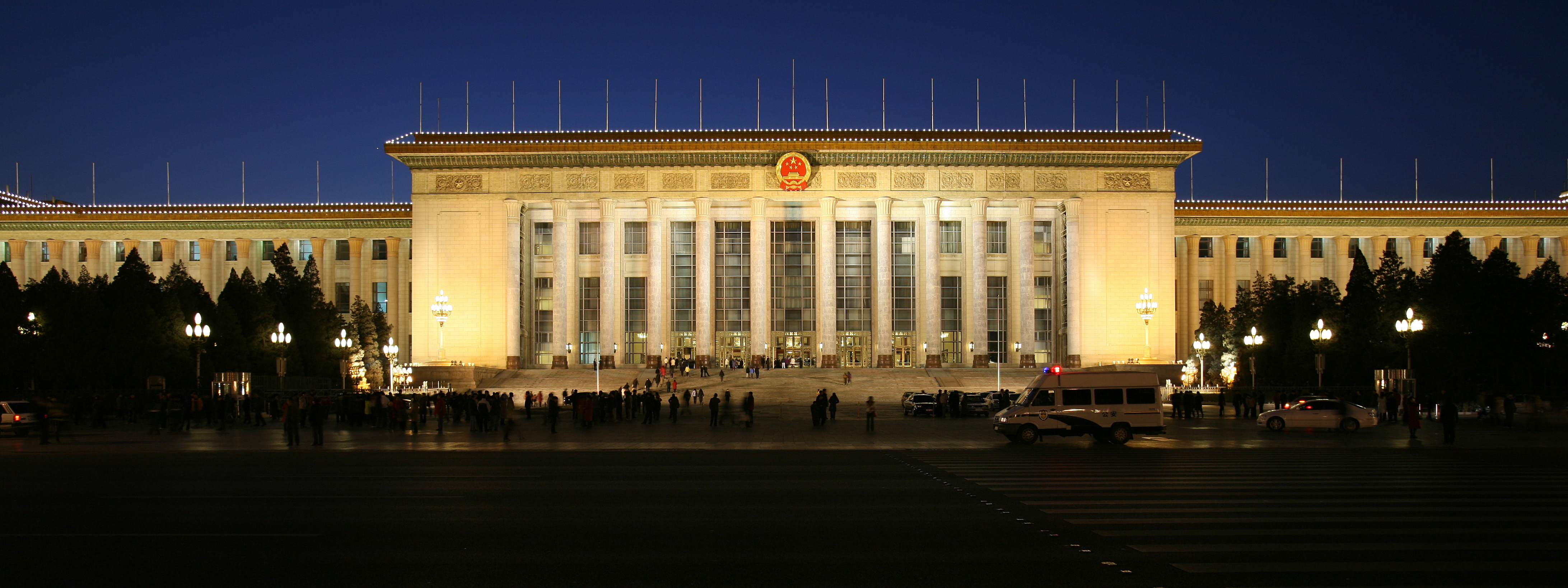 A brightly lit Great Hall of The People at dusk.